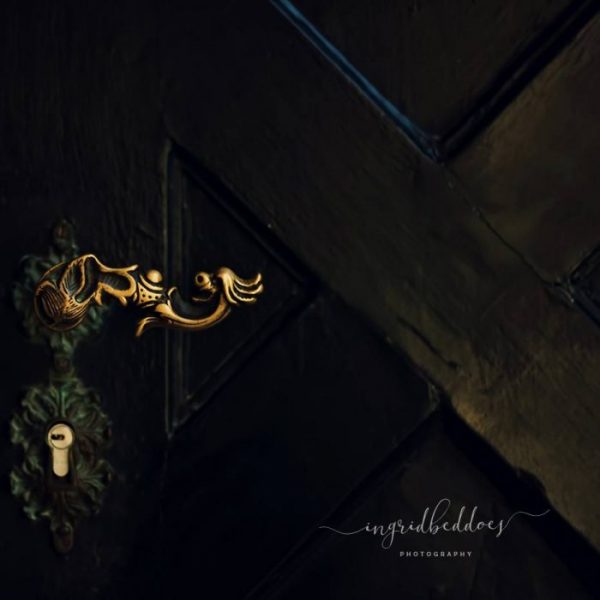 Detailed photograph of a classic door handle from Dubrovnik church. Urban and architecture photography, door handle detail