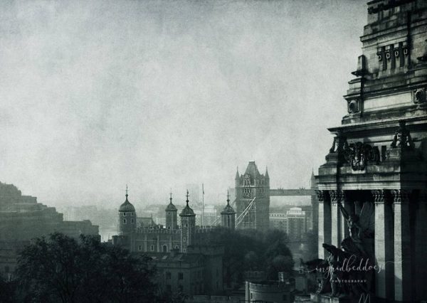 London Blues - Vintage moody blue foggy photograph of London. Early morning foggy London. Blue textured sky with a view to Tower bridge. London architecture
