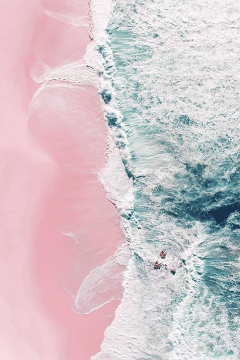 Pink Beach Aerial Photography captures the waves braking around small rocks and in the same way rolling on a pink sand beach.