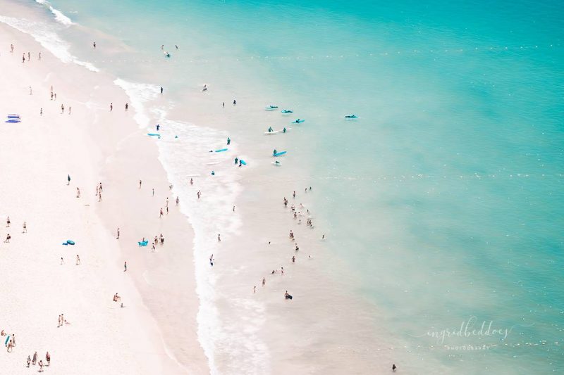 Beach Love V - Aerial Beach Photo. Pink sandy beach with baby blue waters. Surfers and beach lovers by Ingrid Beddoes