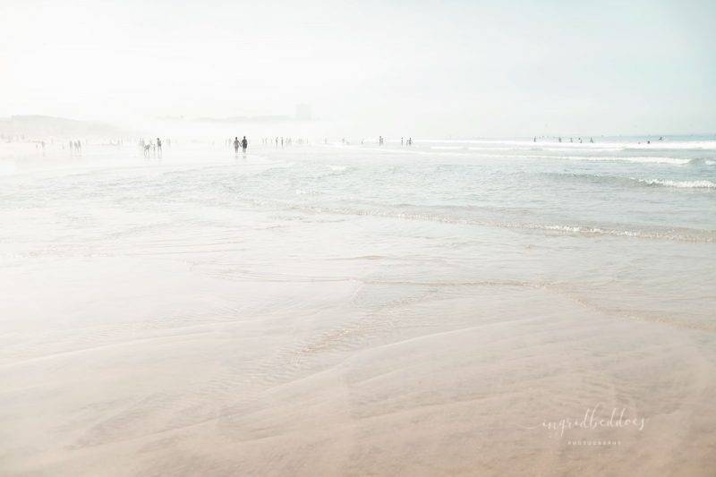 People walking by seaside on a foggy morning. Beach photographic print of 