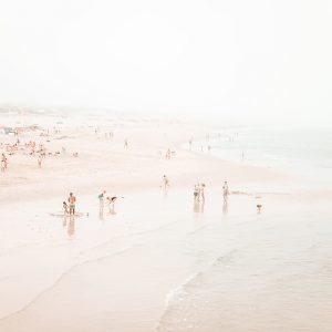 People playing at the beach IX. Beach photographic print in pastel colors